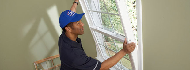 man replacing double glazing window